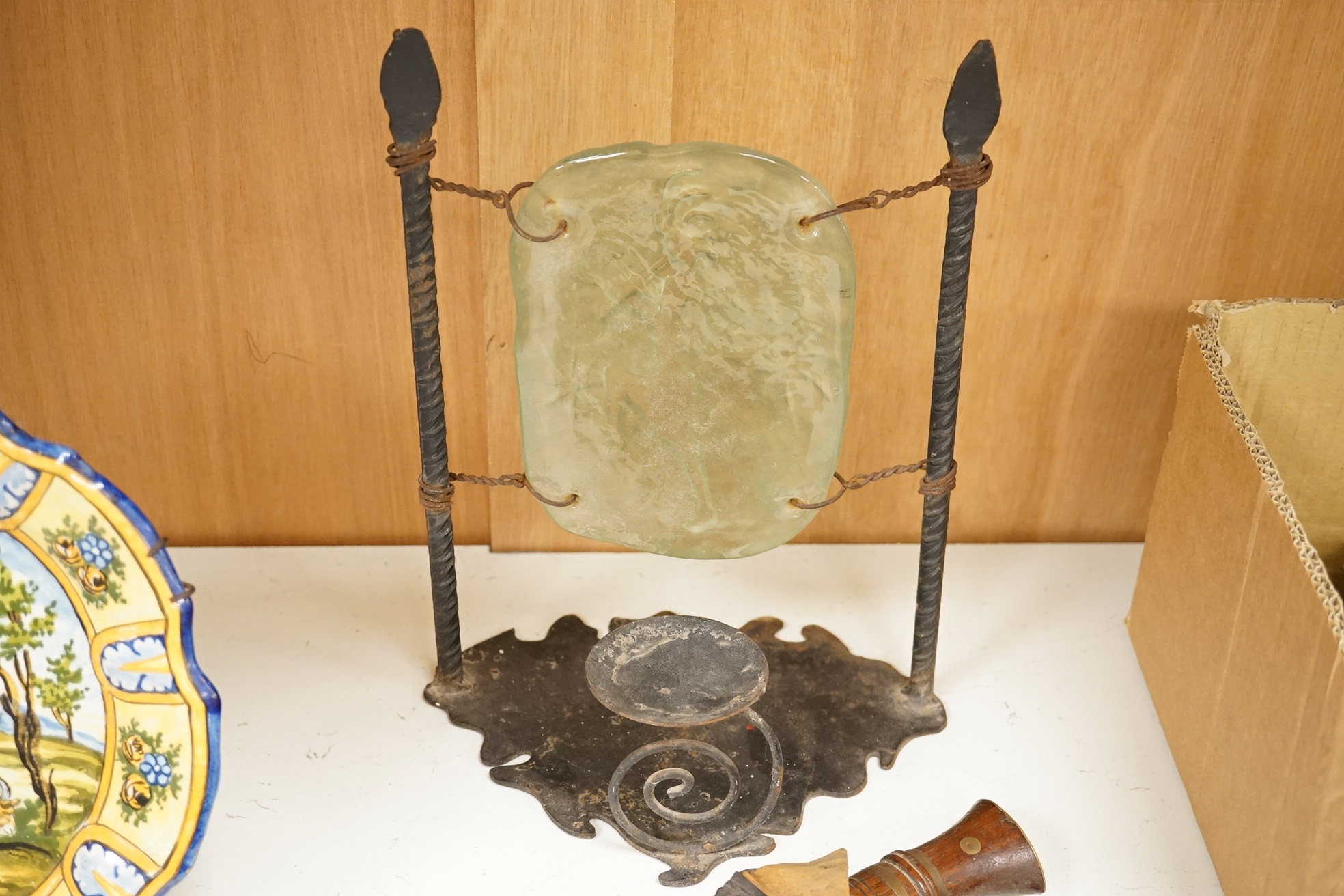 An Indian Kukri with brass mounted wooden handle its leather sheath, and a Moroccan Jambiya, together with a hardstone and wrought iron candle stand